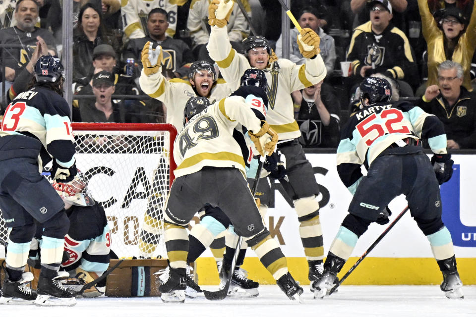 Vegas Golden Knights right wing Jonathan Marchessault, rear, and center Jack Eichel (9) celebrate after Eichel scored against the Seattle Kraken during the first period of an NHL hockey game Thursday, March 21, 2024, in Las Vegas. (AP Photo/David Becker)