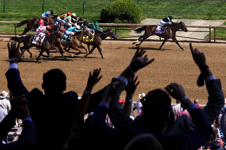 Spectators cheer during race ten as Flagstaff, ridden by jockey Luis Saez, pulls ahead of the pack in the final stretch, on the day of the 147th Kentucky Derby at Churchill Downs. May 1, 2021