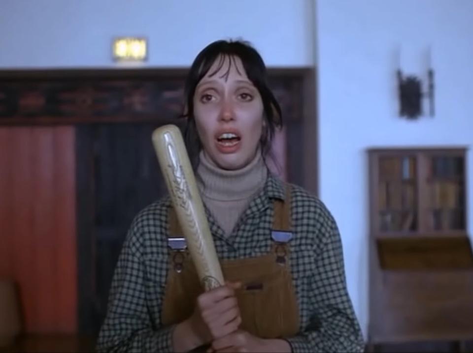Wendy holding a bat in the Overlook Hotel lounge in "The Shining"