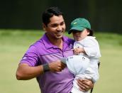 <p>Jason Day of Australia walks with his son Dash during the Par Three Contest prior to the start of the 2014 Masters Tournament at Augusta National Golf Club on April 9, 2014 in Augusta, Georgia. (Photo by Harry How/Getty Images) </p>