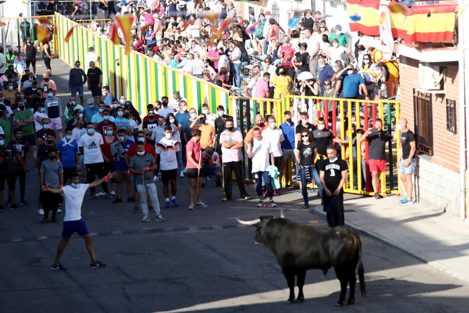 Revellers and spectators watch a steer during the first running-of-the-bull festival since the coronavirus disease (COVID-19) pandemic began in Villaseca de la Sagra, central Spain, September 5, 2021. REUTERS/Sergio Perez