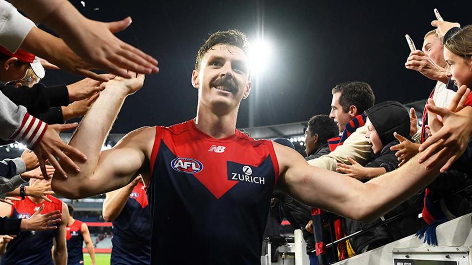 Jake Lever (pictured) high fives fans after winning a match.