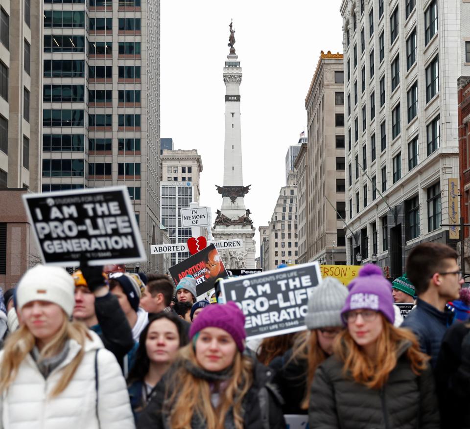 Attendees march past the Soldiers and Sailors Monument during the Indiana March for Life event, Monday, Jan. 24, 2022, in Indianapolis.