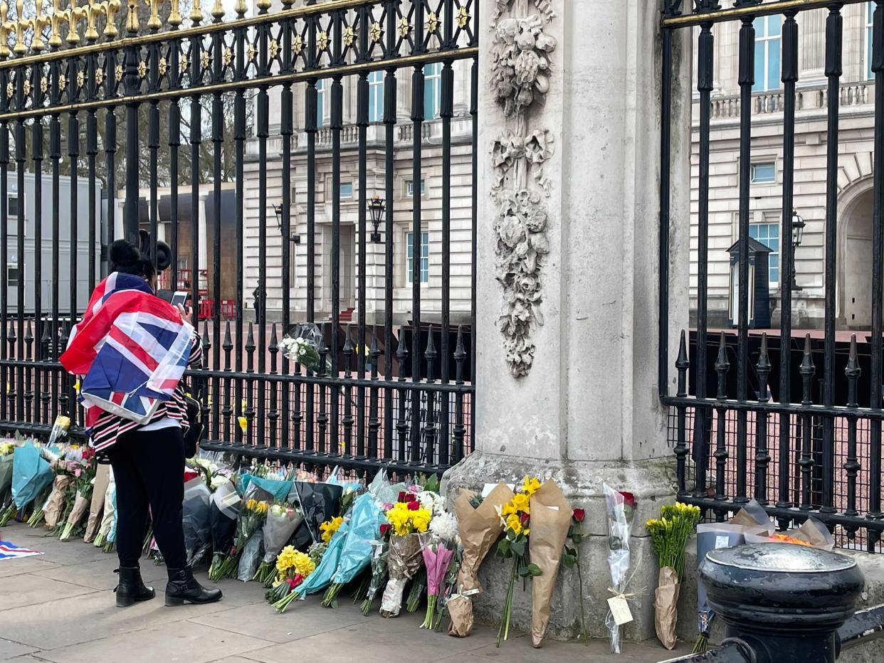 Flowers are laid in front of Buckingham Palace in honour of Prince Philip on 9 April, 2021.  (Kate Ng)