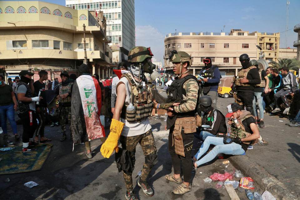 Anti-government protesters gather on Rasheed Street in Baghdad, Iraq, Wednesday, Nov. 27, 2019. Several protesters were killed by security forces who fired live rounds in Baghdad and southern Iraq amid ongoing violence and days of sit-ins and road closures, Iraqi officials said Wednesday. (AP Photo/Khalid Mohammed)