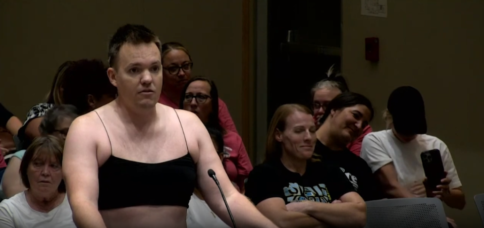 "I can't think of any place of work where I could walk in an interview and be taken serious in something like this," Ira Latham, a father protesting the school dress code policy, said at the board meeting.