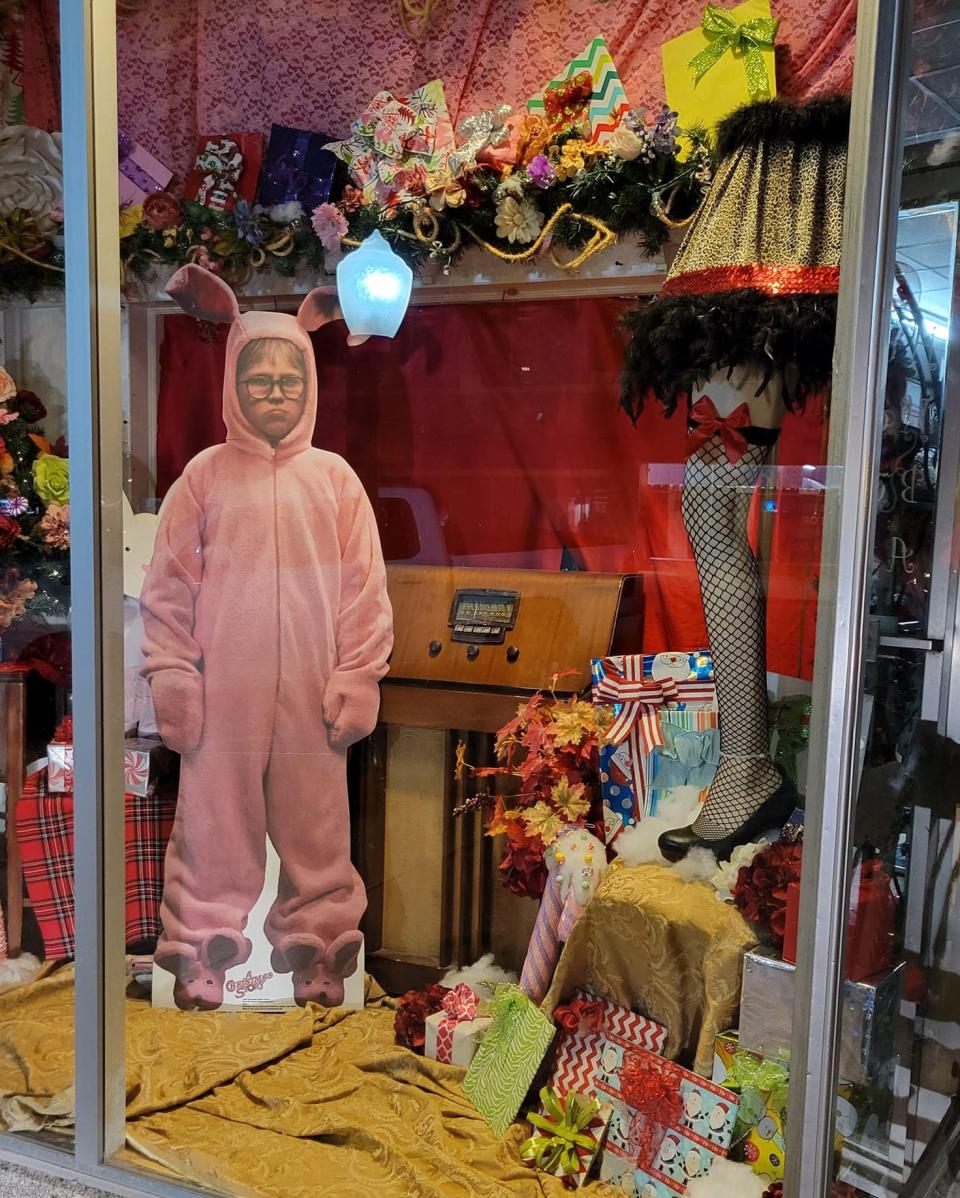 "A Christmas Story"-theme display decorates the windows of Hoffman House Boutique in downtown Chickasha on Oct. 25, 2022. Just a few blocks away on Chickasha Avenue, a new park features as its centerpiece a 50-foot-tall version of the famed leg lamp from the 1983 film.