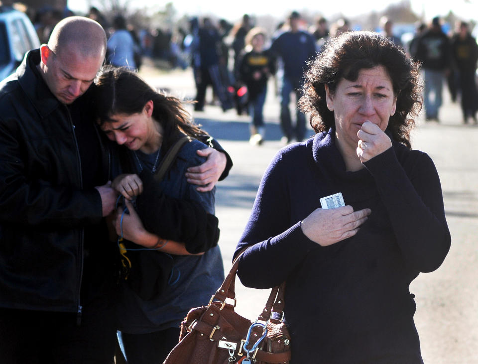 FILE - In this Jan. 14, 2014 file photo, a woman waits at a staging ground area where families are being reunited with Berrendo Middle School students after a shooting at the school in Roswell, N.M. Although still relatively rare, there?s been no real reduction in the number of school shootings since security was beefed up around the country with measures such as safety drills and the hiring of police officers, after the rampage at Connecticut's Sandy Hook Elementary School in December 2012. (AP Photo/Roswell Daily Record, Mark Wilson, File)