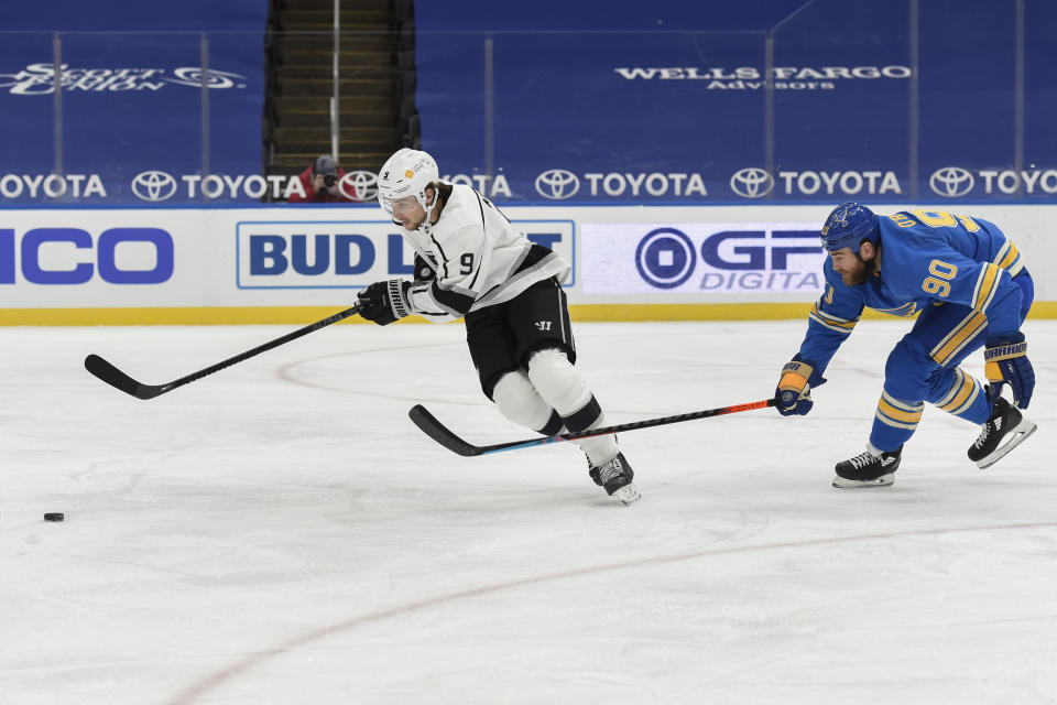 St. Louis Blues' Ryan O'Reilly (90) pressures Los Angeles Kings' Adrian Kempe (9) during the third period of an NHL hockey game Saturday, Jan. 23, 2021, in St. Louis. (AP Photo/Joe Puetz)