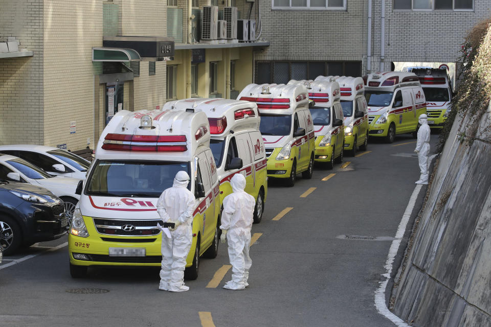 Ambulances carrying patients infected with the novel coronavirus arrive at a hospital in Daegu, South Korea, Sunday, Feb. 23, 2020. South Korea's president has put the country on its highest alert for infectious diseases and says officials should take "unprecedented, powerful" steps to fight a viral outbreak.(Lim Hwa-young/Yonhap via AP)