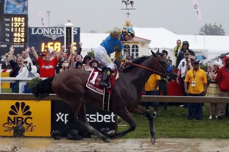 May 16, 2015; Baltimore, MD, USA; Victor Espinoza aboard American Pharoah celebrates winning the 140th Preakness Stakes at Pimlico Race Course. Mandatory Credit: Peter Casey-USA TODAY