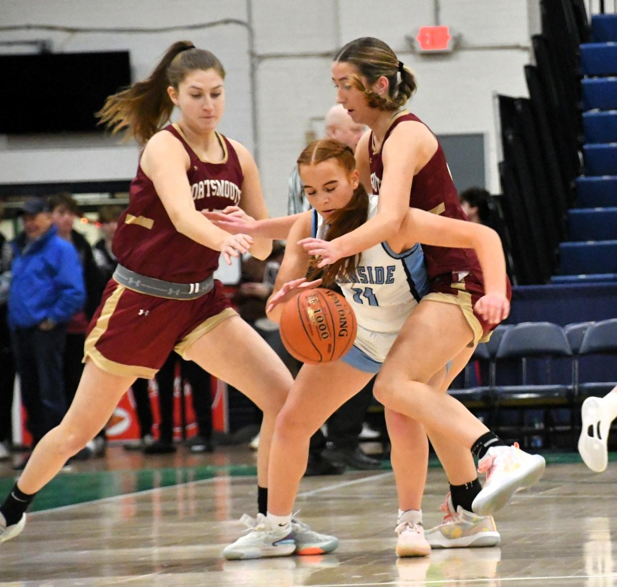 Portsmouth’s Bridget Emery, left, and Avery Romps defend Oceanside’s Aubri Hoose during the Varsity Maine Holiday Hoops Showcase Thursday at the Portland Expo