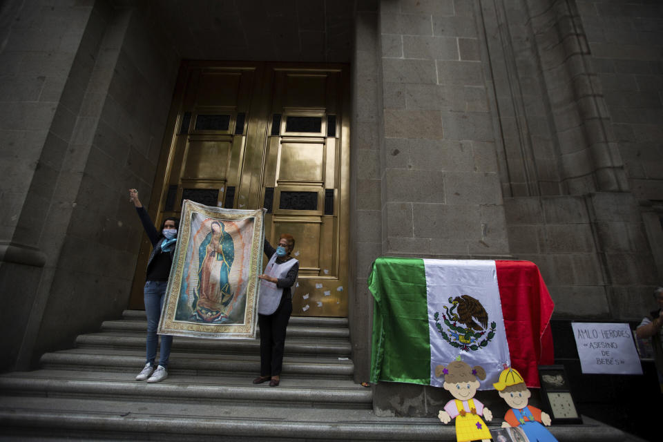 Activists against abortion hold up an image of Our Lady of Guadalupe at the entrance of the Supreme Court to celebrate the court's decision against an injunction in Veracruz state that aimed to decriminalize abortion for all cases within the first 12 weeks of pregnancy in Mexico City, Wednesday, July 29, 2020. Two of Mexico’s 32 states have decriminalized abortion. (AP Photo/Fernando Llano)