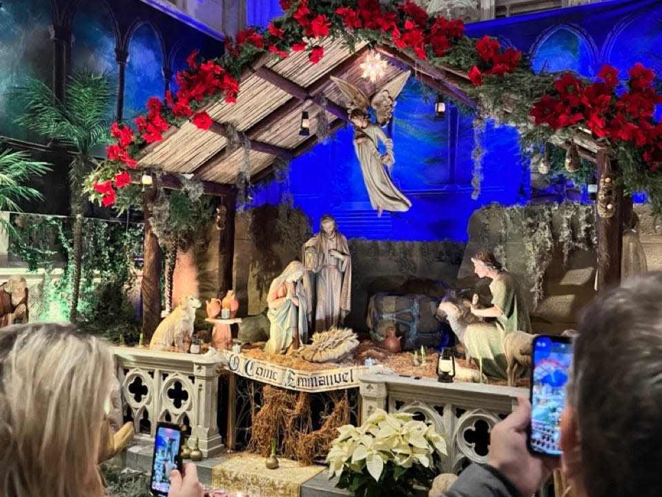 people taking pics of the manger