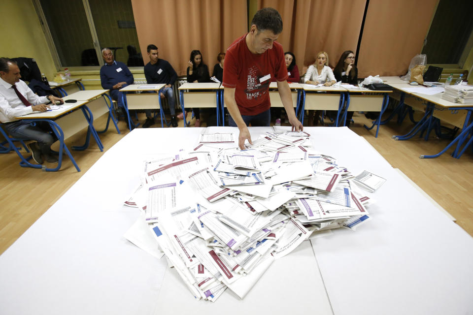 Bosnian election workers prepare to count ballots at a polling station in Sarajevo, Bosnia, on Sunday, Oct. 7, 2018. Bosnians decide in a tense election this weekend whether to cement the ethnic divisions stemming from the 1992-95 war by supporting nationalist politicians or push for changes that would pave the way toward European Union and NATO integration. (AP Photo/Amel Emric)