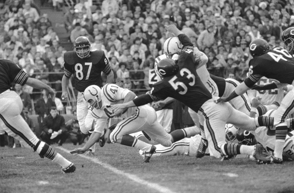 FILE - Baltimore Colts back Tom Matte (41) trips over a teammate after a two-yard gain in the first quarter against the Chicago Bears on Oct. 8, 1967, in Chicago. He was downed by Chicago Bears end Ed O'Bradovich (87). Baltimore won 24-3. Matte, who spent his entire 12-year NFL career as a gritty running back for the Baltimore Colts _ except for a star turn for three games in 1965 as their quarterback _ has died. He was 82. The Baltimore Ravens confirmed Matte's death during coach John Harbaugh's news conference Wednesday, Nov. 3, 2021. No details were provided.(AP Photo/Charles Harrity/File)
