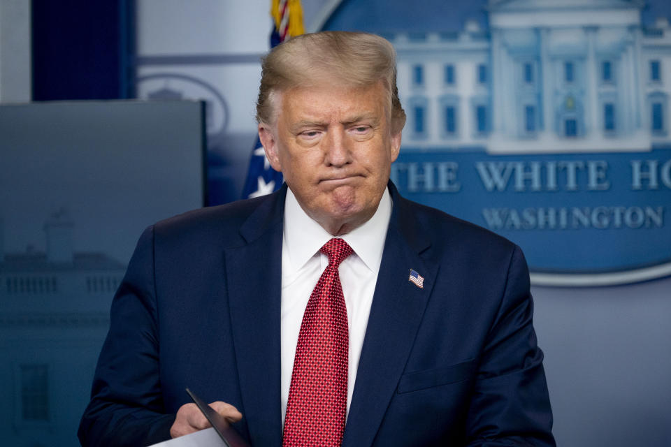 President Donald Trump returns to a news conference in the James Brady Press Briefing Room after he briefly left because of a security incident outside the fence of the White House, Monday, Aug. 10, 2020, in Washington. (AP Photo/Andrew Harnik)