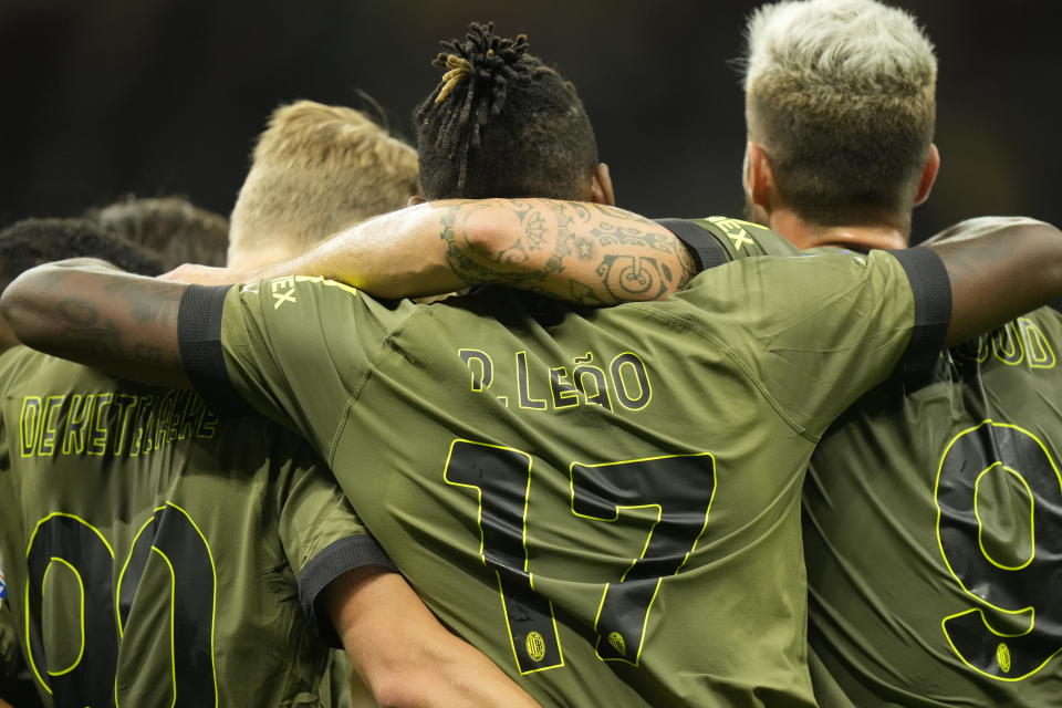 AC Milan's Rafael Leao, centre, celebrates with his teammates after scoring his side's opening goal during a Serie A soccer match between AC Milan and Bologna at the San Siro stadium in Milan, Italy, Saturday, Aug. 27, 2022. (AP Photo/Luca Bruno)