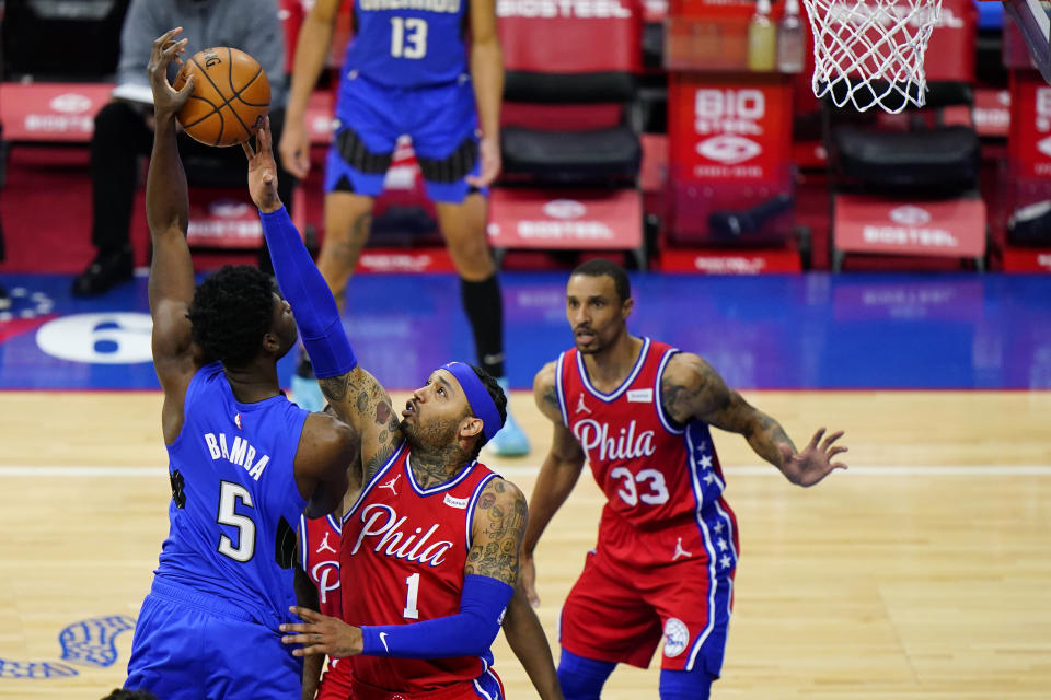 Orlando Magic's Mo Bamba, left, cannot get a shot past Philadelphia 76ers' Mike Scott during the second half of an NBA basketball game, Friday, May 14, 2021, in Philadelphia. (AP Photo/Matt Slocum)