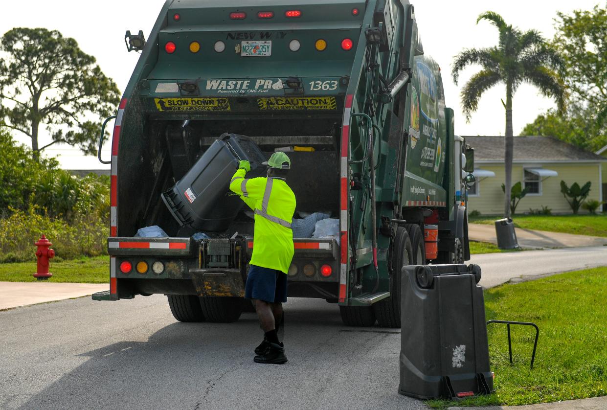 Leroy Green, a Waste Pro garbage collection crewman, works the California and Del Rio Boulevards route, collecting regular garbage and bulky items on Tuesday, April 21, 2020, in Port St. Lucie. 