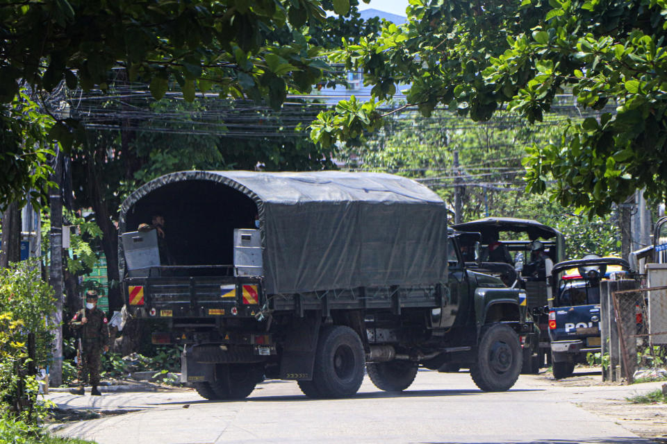 A police vehicle is parked at a road in South Okkalapa township to block anti-coup protesters' gathering in Yangon, Myanmar, Friday, April 9, 2021. An information blackout under Myanmar's military junta worsened Thursday as fiber broadband service, the last legal way for ordinary people to access the internet, became intermittently inaccessible on several networks. (AP Photo)
