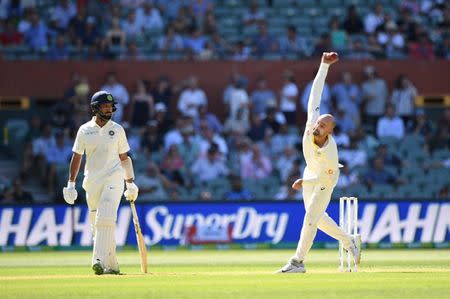 India's Cheteshwar Pujara looks on as Australia's Nathan Lyon bowls on day one of the first test match between Australia and India at the Adelaide Oval in Adelaide, Australia, December 6, 2018. AAP/Dave Hunt via REUTERS