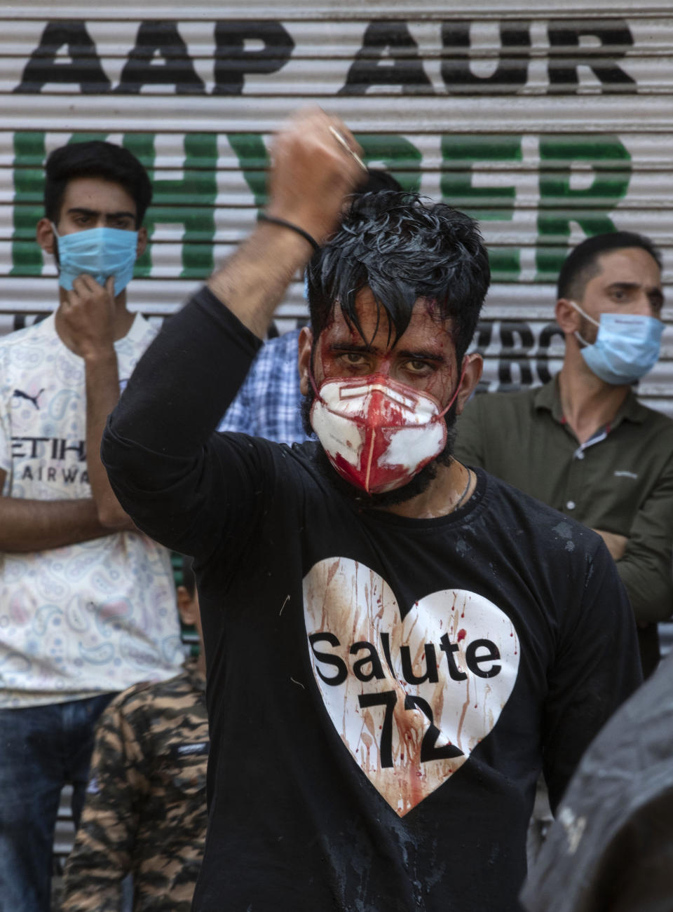 A Kashmiri Shiite Muslims wearing a mask flagellates himself during a Muharram procession in Srinagar, Indian controlled Kashmir, Saturday, Aug. 29, 2020. Muharram is a month of mourning in remembrance of the martyrdom of Imam Hussein, the grandson of Prophet Mohammed. Authorities had imposed restrictions in parts of Srinagar, the region's main city, to prevent gatherings marking Muharram from developing into anti-India protests. (AP Photo/Mukhtar Khan)