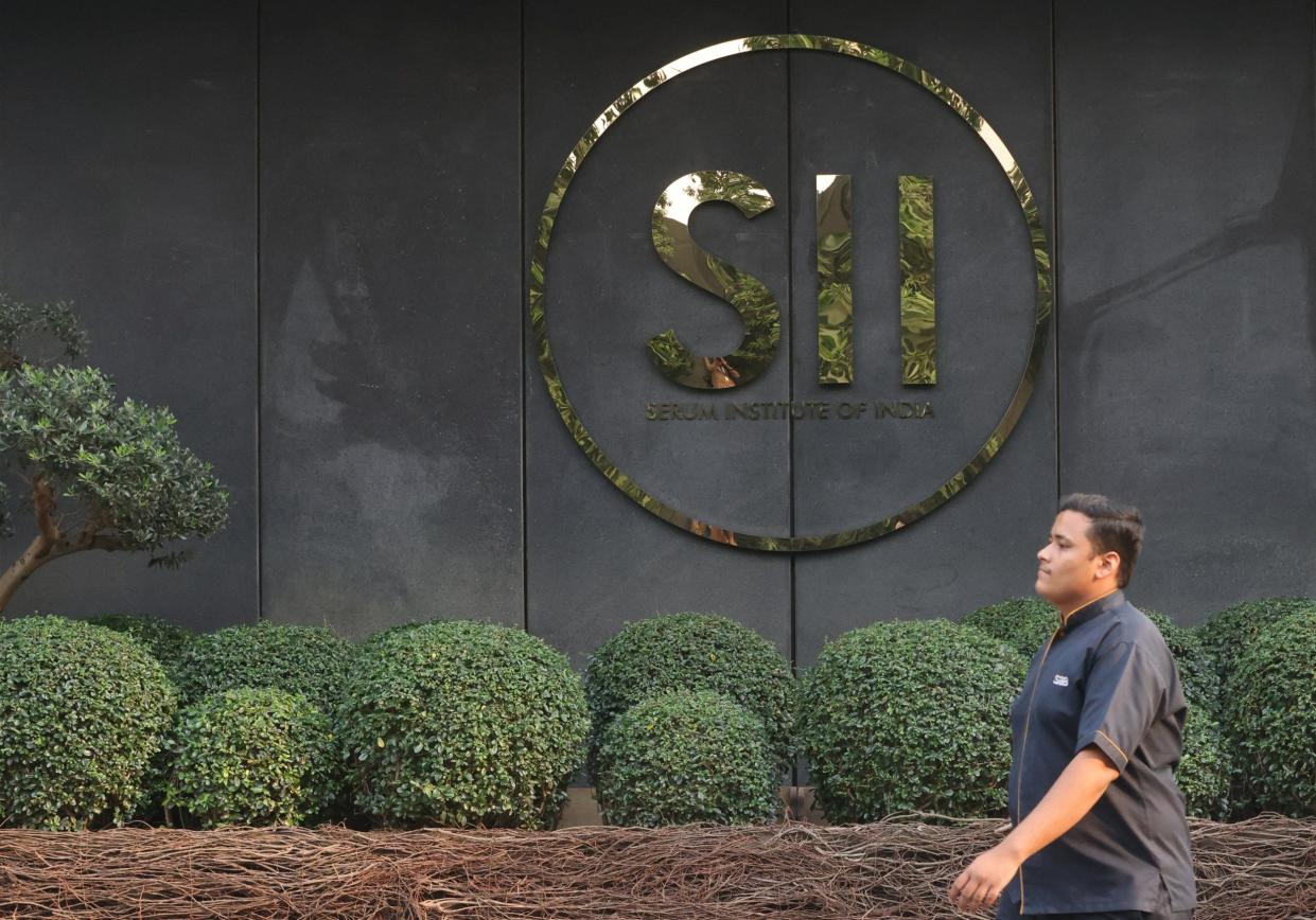 A man walks past the logo of the Serum Institute of India, inside the facility in Pune, India