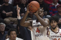 Virginia Tech guard Nahiem Alleyne (4) shoots from long range as someone signals a three pointer from the bench against North Carolina during the second half of an NCAA college basketball game in Blacksburg, Va., Wednesday, Jan. 22, 2020.(AP Photo/Lee Luther Jr.)