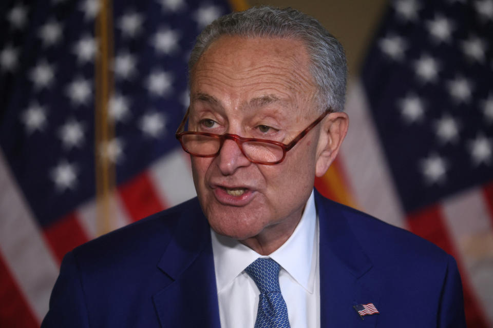 Sen. Chuck Schumer against the backdrop of the U.S. flag.