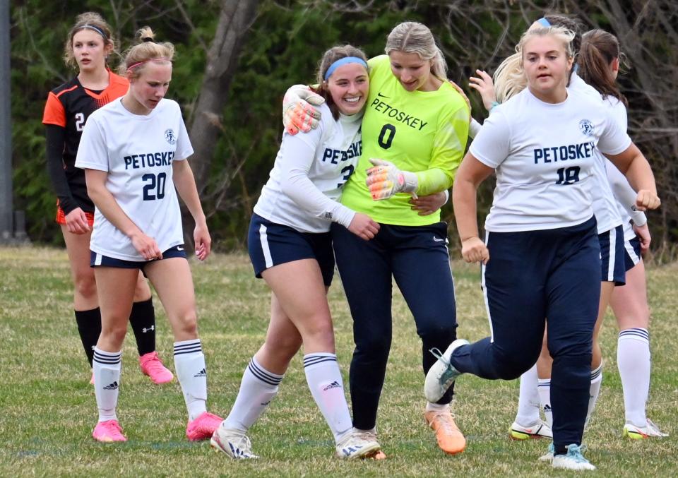 Petoskey keeper Sadie Corey (0) runs in to celebrate with teammate Claire O'Donnell after her first varsity score against Harbor Springs Thursday.