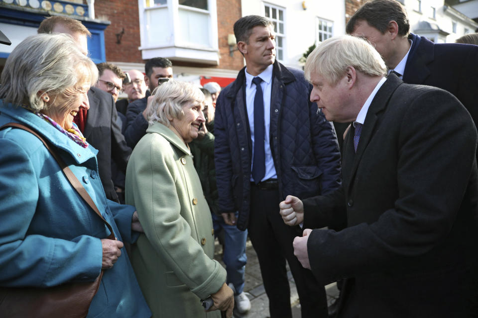 Boris Johnson talks to passers-by, as he visits a Christmas market in Salisbury