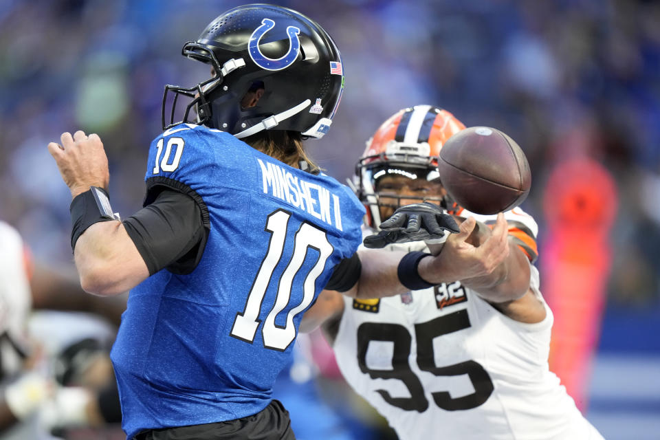 Indianapolis Colts quarterback Gardner Minshew (10) fumbles the ball as he is hit by Cleveland Browns defensive end Myles Garrett (95) in the end zone during the first half of an NFL football game, Sunday, Oct. 22, 2023, in Indianapolis. (AP Photo/AJ Mast)