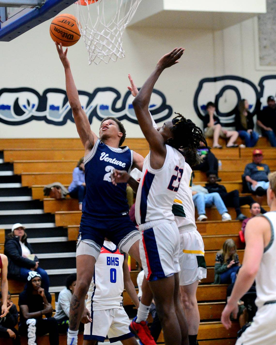 Venture Academys Mario Williams (20) goes up for a layup over Modesto Christians Drevon Johnson during the 27th Annual Six County All Star Senior Basketball Classic Boys game at Modesto Junior College in Modesto California on April 27, 2024. The Red team beat the Blue team 81-79. John Westberg