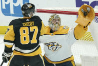 Nashville Predators goaltender Juuse Saros, right, makes a save in front of Pittsburgh Penguins' Sidney Crosby (87) during the first period of an NHL hockey game, Monday, April 15, 2024, in Pittsburgh. (AP Photo/Matt Freed)