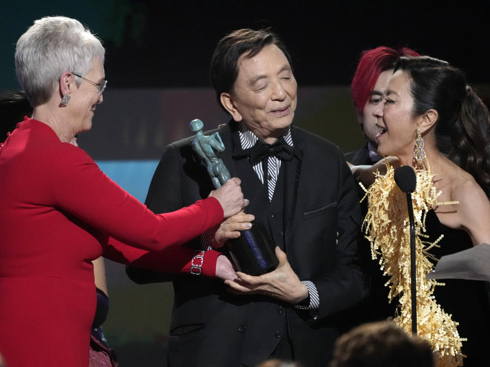 Jamie Lee Curtis, from left, James Hong, and Michelle Yeoh accept the award for outstanding performance by a cast in a motion picture for "Everything Everywhere All at Once," at the 29th annual Screen Actors Guild Awards on Sunday, Feb. 26, 2023, at the Fairmont Century Plaza in Los Angeles. (AP Photo/Chris Pizzello)