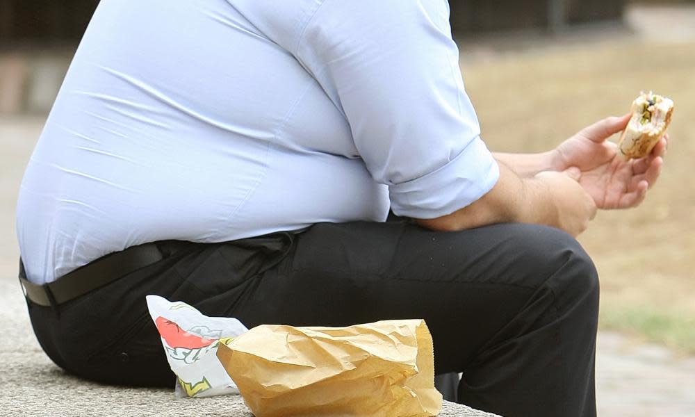 An overweight man eating