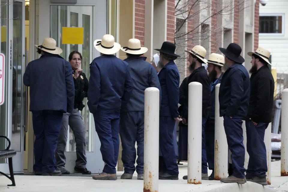 FILE - A group of Amish gather outside the Crawford County Judicial Center in Meadville, Pa., following a preliminary hearing, March 15, 2024, for Shawn C. Cranston, 52, of Corry, Pa., who is accused of killing Rebekah Byler and her unborn child inside the Byler home near Spartansburg, Pa., on Feb. 26. Six guns, a variety of ammunition and a pair of sneakers that may match tread marks left at the murder scene were seized during searches of the home and vehicle of a man accused of killing the pregnant Amish woman in her rural Pennsylvania home a month ago. (AP Photo/Gene J. Puskar, file)