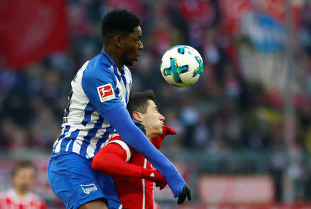 Soccer Football - Bundesliga - Bayern Munich vs Hertha BSC - Allianz Arena, Munich, Germany - February 24, 2018 Hertha Berlin’s Jordan Torunarigha in action with Bayern Munich's Robert Lewandowski REUTERS/Michaela Rehle