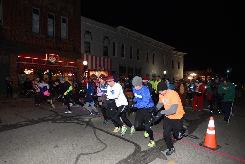 Runners are pictured taking off from the starting line during the 2018 Hot-Cha-Cha 5K Mug Run in Blissfield, held in December as a fundraiser for the Miss River Raisin Scholarship Program. Holiday costumes and lights are encouraged to be worn by the participants.