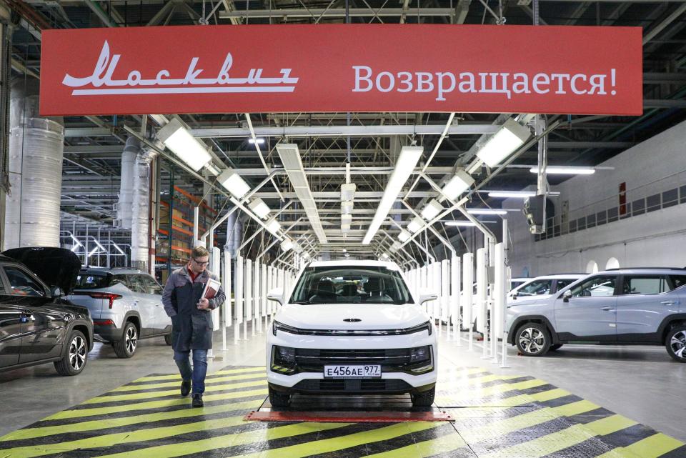 New made "Moskvich" cars are seen at the assembly shop of Moscow Automobile Plant "Moskvich" with the banner reads: "Moskvich (Muscovite) returns" in Moscow, Russia, Wednesday, Nov. 23, 2022. The auto industry is facing bigger hurdles to adapt. Russia launched production of the Moskvich car brand at a plant near Moscow given up by the French carmaker Renault, with a new, modern Chinese design that barely resembles the Soviet-era classic. (Kirill Zykov, Moscow News Agency via AP)
