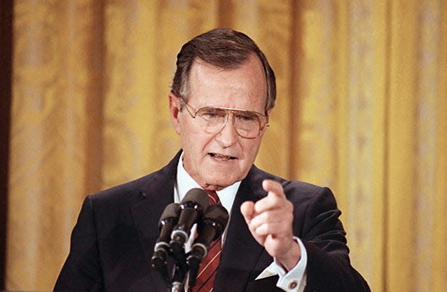 President George Bush responds to a reporter's question during his first prime time televised news conference in the East Room of the White House in Washington, June 8, 1989.