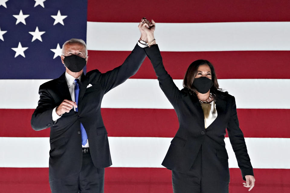 Former Vice President Joe Biden, Democratic presidential nominee, left, and Senator Kamala Harris, Democratic vice presidential nominee, wear protective masks while holding hands outside the Chase Center during the Democratic National Convention in Wilmington, Delaware, U.S., on Thursday, Aug. 20, 2020. (Stefani Reynolds/Bloomberg via Getty Images)