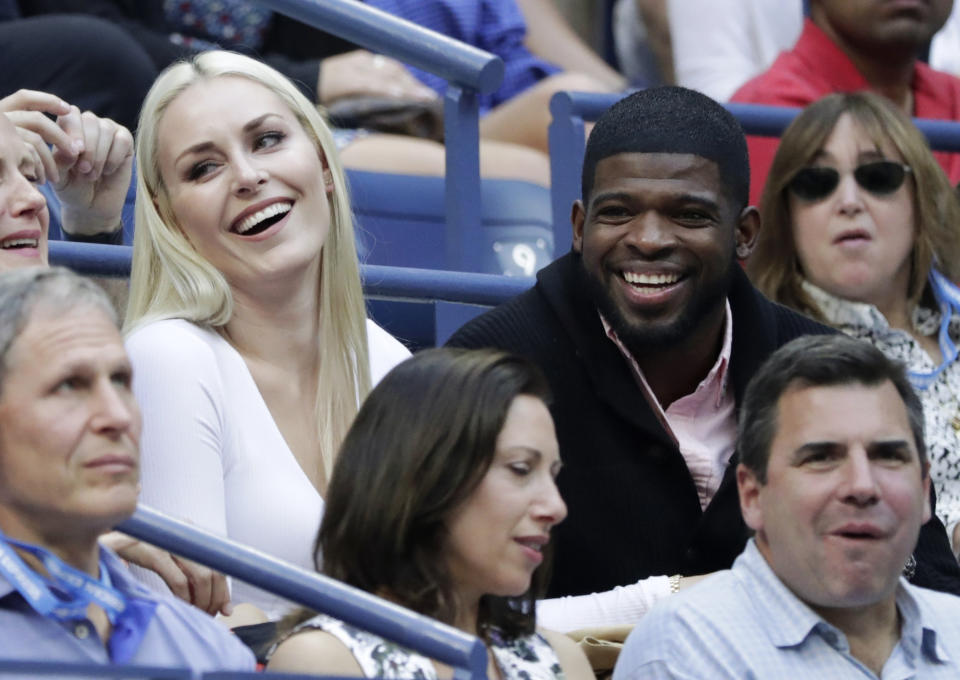 FILE - In this Sept. 8, 2019, file photo, Lindsey Vonn, left, and P.K. Subban talk with friends during the men's singles final of the U.S. Open tennis championships in New York. Subban and the NHL are bringing something new to television Saturday for fans and everyone dealing with the isolation and hardships caused by the coronavirus pandemic. Everything is filmed remotely with Subban hosting the show from his living room in Los Angeles in the house he shares with fiancee and Olympic gold medalist Lindsey Vonn. (AP Photo/Adam Hunger, File)