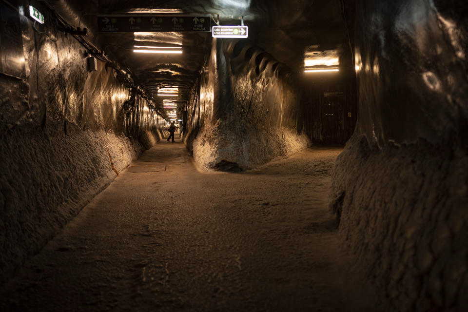 People walk in an access gallery at the Salina Turda, a former salt mine turned touristic attraction, now listed by emergency authorities as a potential civil defense shelter in Turda, central Romania, Monday, Oct. 17, 2022. Fighting around Ukraine's nuclear power plants and Russia's threats to use nuclear weapons have reawakened nuclear fears in Europe. This is especially felt in countries near Ukraine, like Poland, where the government this month ordered an inventory of the country's shelters as a precaution. (AP Photo/Vadim Ghirda)