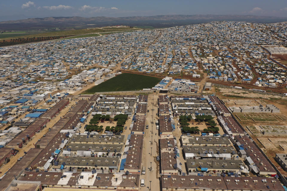 FILE - An aerial view shows a large refugee camp on the Syrian side of the border with Turkey, near the town of Atma, in Idlib province, Syria, April 19, 2020. For years, Syria’s civil war has been a largely frozen conflict, the country effectively carved up into areas controlled by the Damascus government of President Bashar Assad, various opposition groups and Syrian Kurdish forces. But as the conflict entered its 14th year on Friday, March 15, 2024 observers say violence has been on the rise again while the world’s attention is mostly focused on other crises, such as Russia’s onslaught on Ukraine and the Israel-Hamas war in Gaza. (AP Photo/Ghaith Alsayed, File)