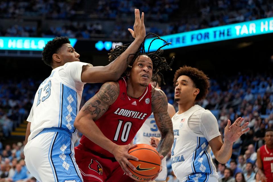 Louisville forward Kaleb Glenn looks for room against Tar Heels forward Jalen Washington (13) and guard Seth Trimble in the first half. Glenn had two points and three rebounds Wednesday night.
