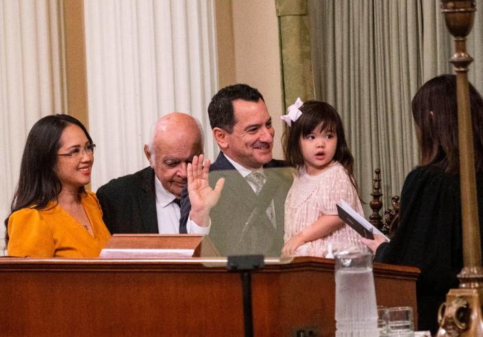 Assembly Speaker Anthony Rendon is sworn in by California Supreme Court Justice Patricia Guerrero during the Assembly organizational session Dec. 5 at the state Capitol. Rendon holds daughter Annie Rendon, 3, and was joined by wife Annie Lam and his father Tom Rendon.