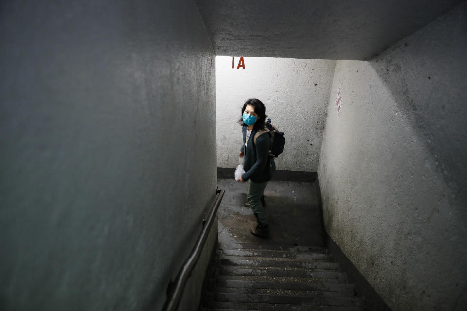 Dr. Jeanie Tse, chief medical officer at the Institute for Community Living, walks down a stairwell towards the exit of the a public housing complex after administering antipsychotic medication to a patient living with schizophrenia, Wednesday, May 6, 2020, in the Brooklyn borough of New York. (AP Photo/John Minchillo)