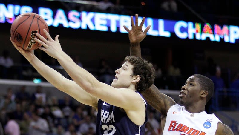 BYU's Jimmer Fredette (32) goes up for a shot in front of Florida's Kenny Boynton (1) during the first half of the NCAA Southeast regional college basketball semifinal game Thursday, March 24, 2011, in New Orleans.